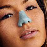Load image into Gallery viewer, Woman wearing blue colored sunscreen on her nose
